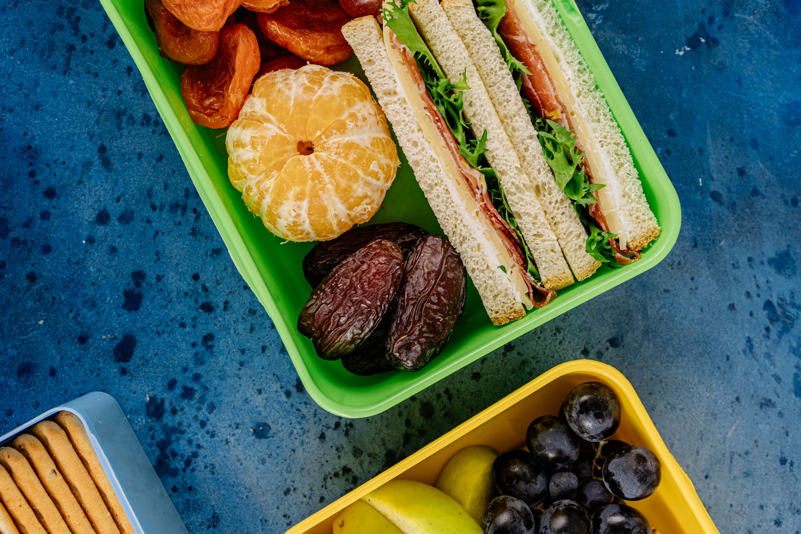 Sandwiches and fruit in colourful lunchboxes